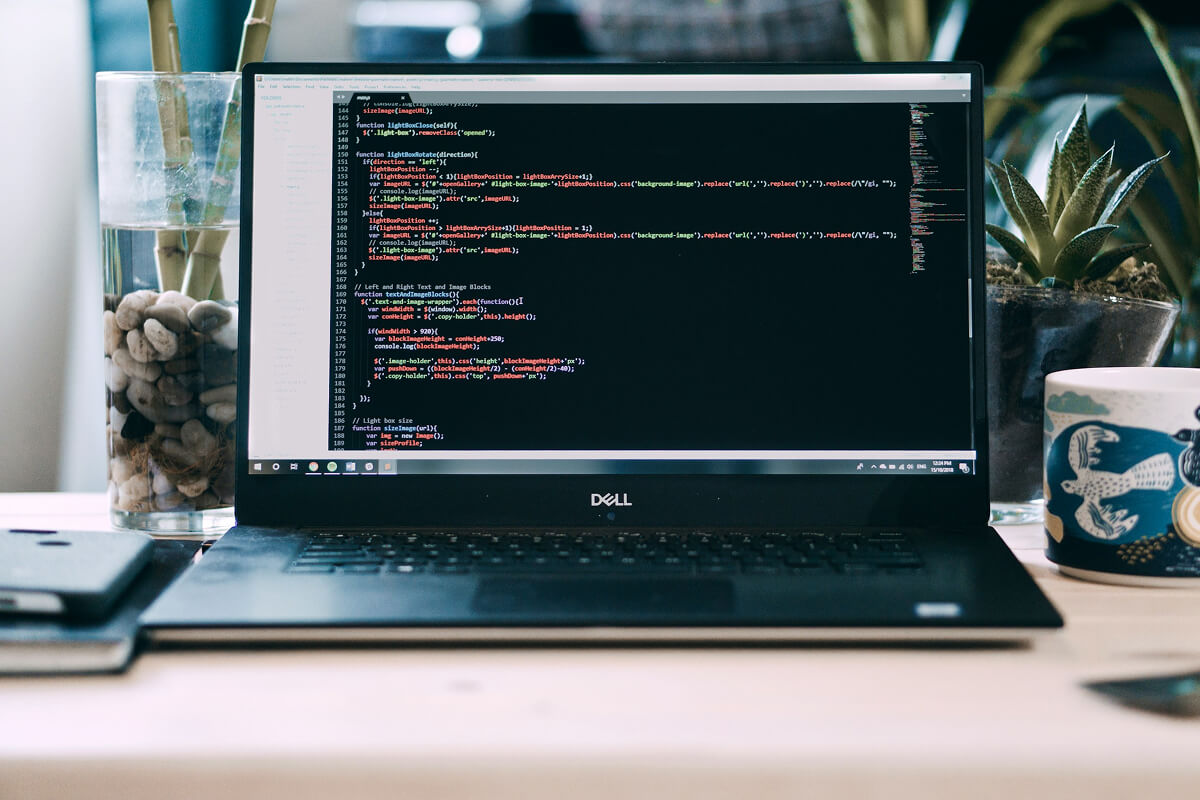 Developer coding an AI SaaS platform for 2026 cost comparison.