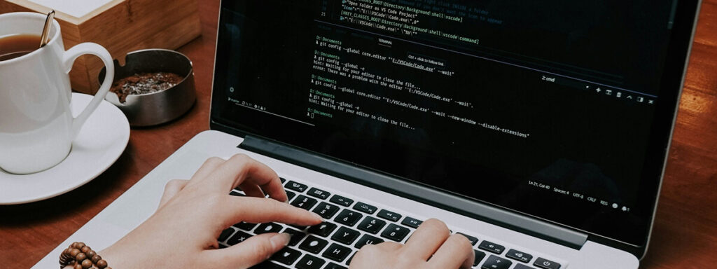 Person coding on a MacBook Pro.