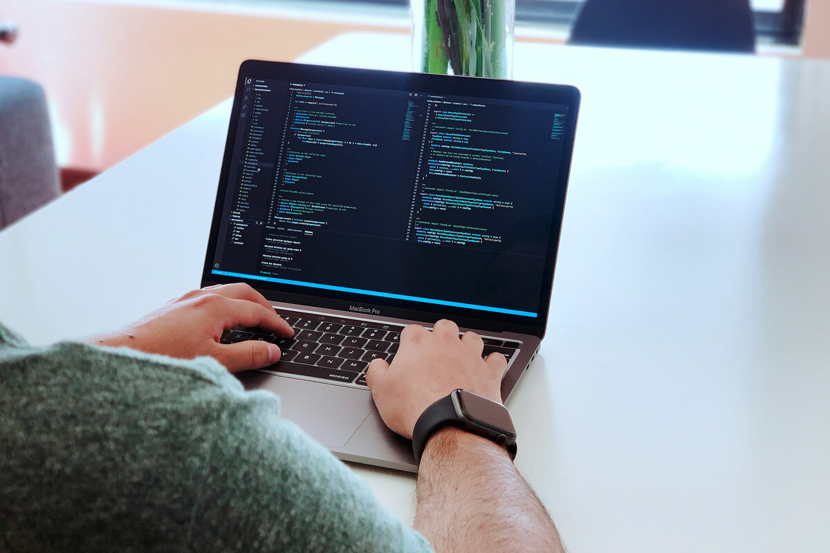 ai-powered software development coding testing and system design — developer working on code at desk - Photo by Zayed Hossain on Pexels