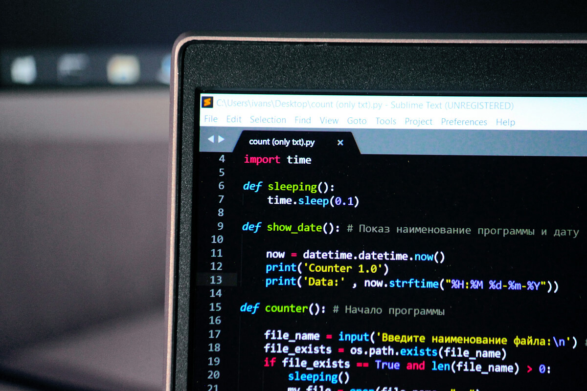 ai software development cost — developer working on code at desk - Photo by Zayed Hossain on Pexels