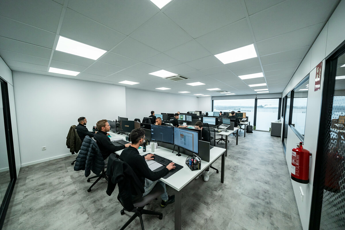 Alt text: Developers working in a modern office workspace.