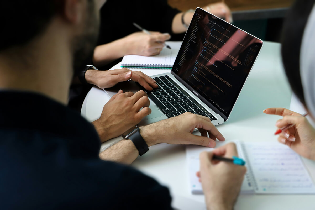 Developers collaborating on code during a team meeting.